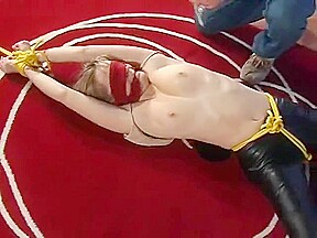 Bound and blindfolded legs spread in leather trousers