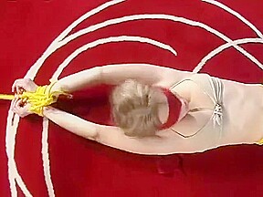 Bound and blindfolded legs spread in leather trousers