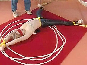 Bound and blindfolded legs spread in leather trousers
