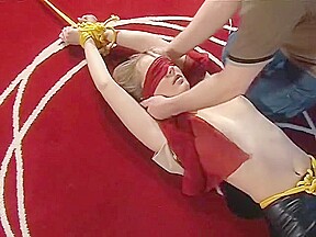 Bound and blindfolded legs spread in leather trousers