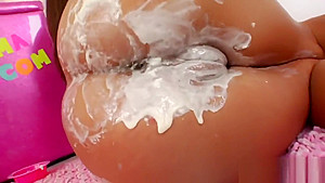 Flirty lesbos fill up their big butts with cream and ejaculate it out